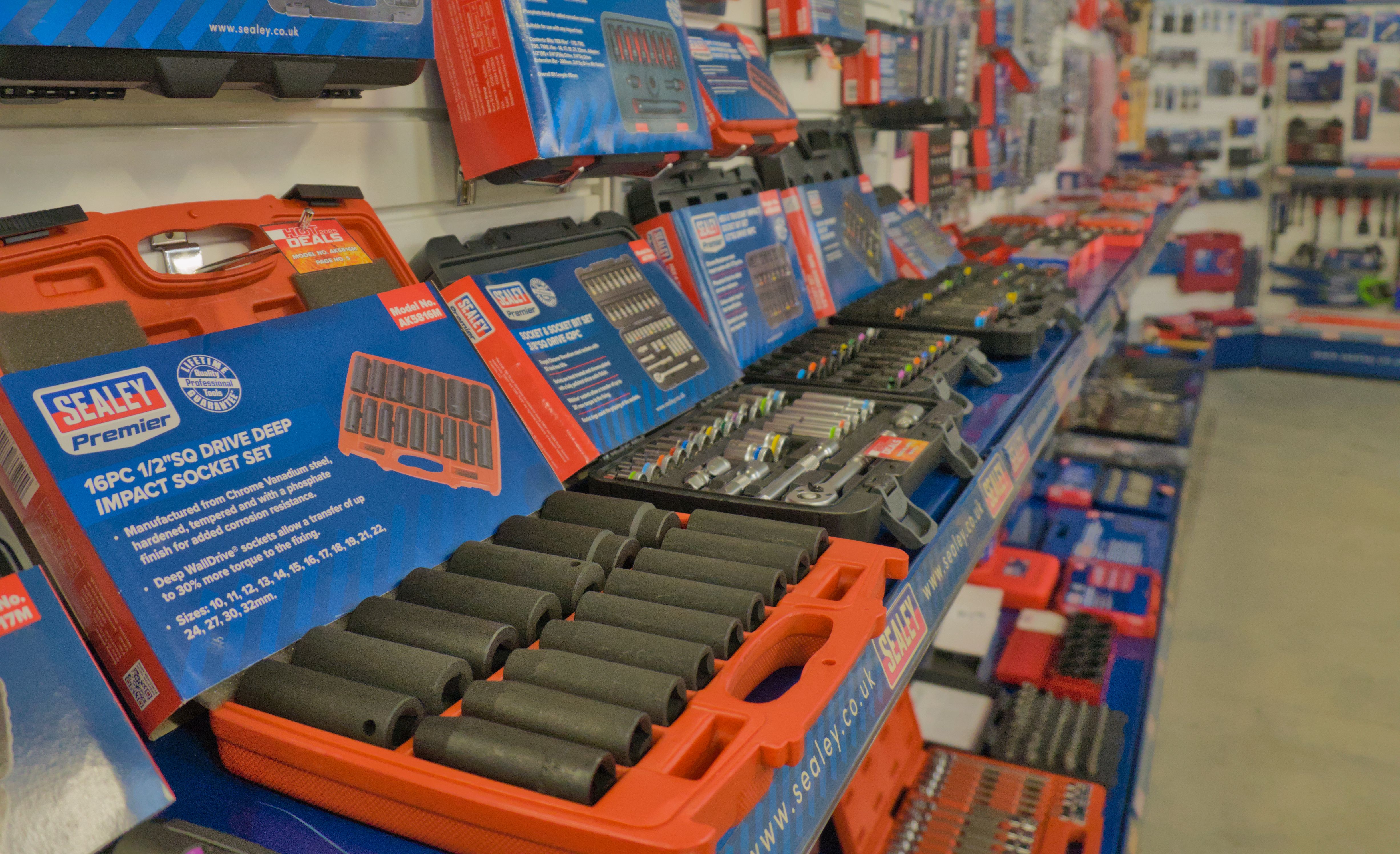 a showroom, featuring an open socket set and many other tools.